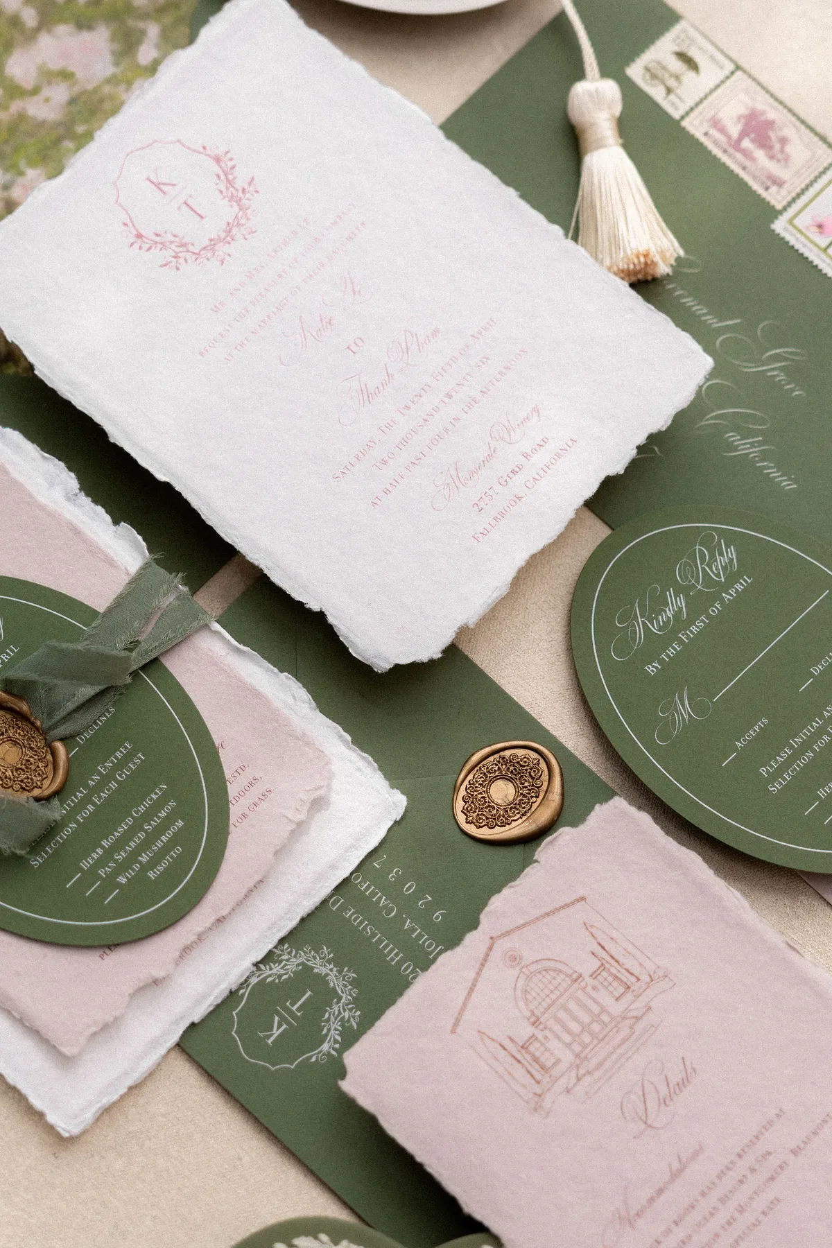 The invitation suite: deckled cards, a wax seal and ribbon on olive-green paper
