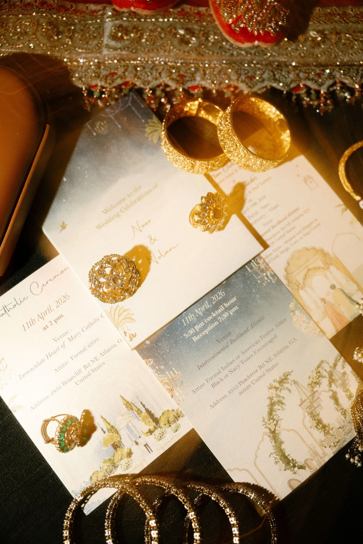 The invitation cards laid among gold bangles and jewellery
