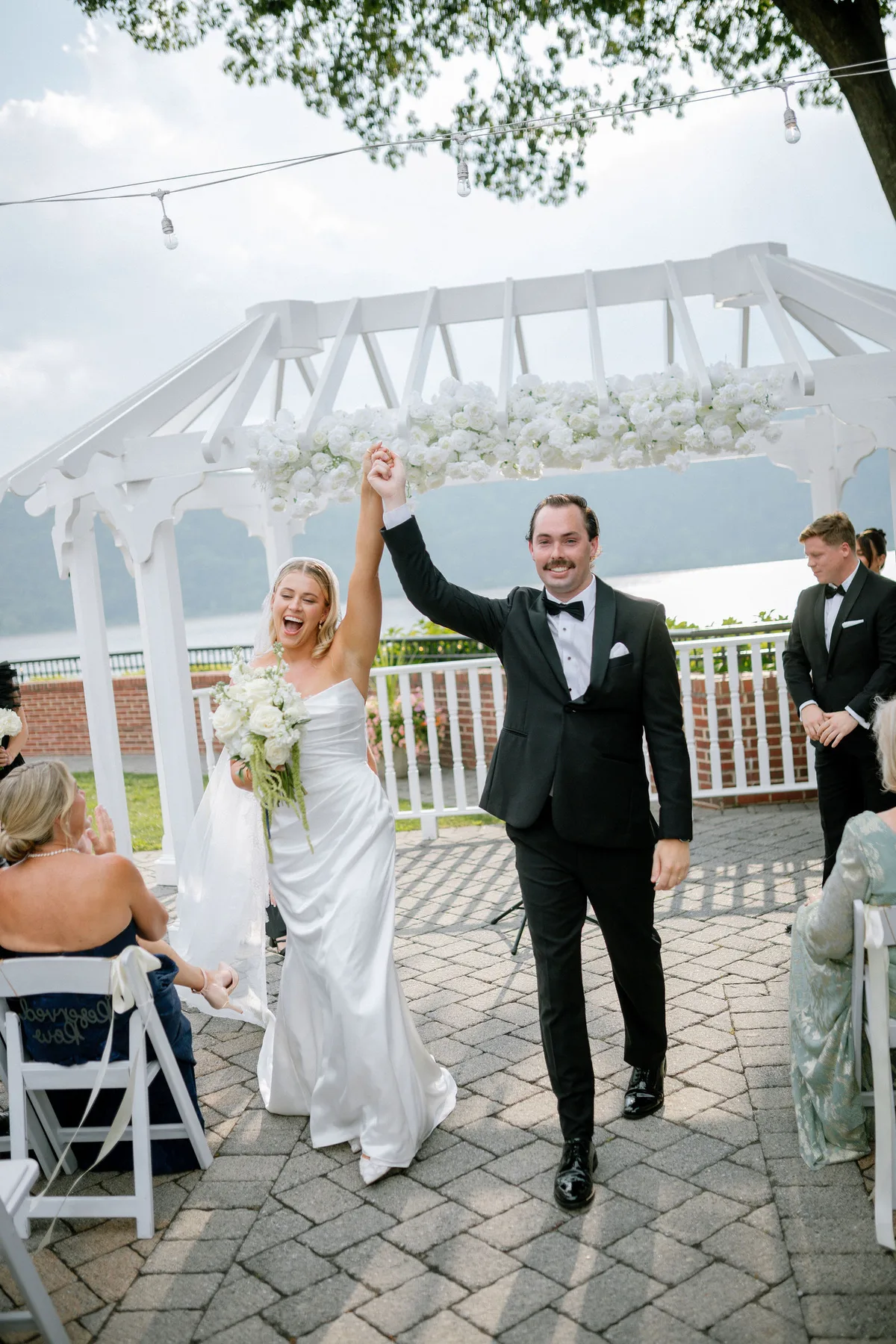 A couple coming back up the aisle with their hands in the air