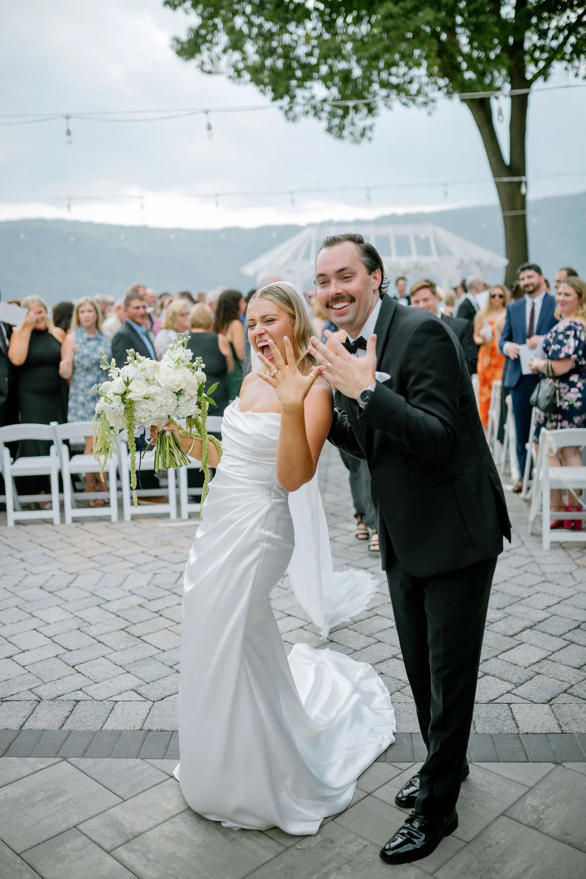 A bride in a lace dress and flower crown, photographed in window light